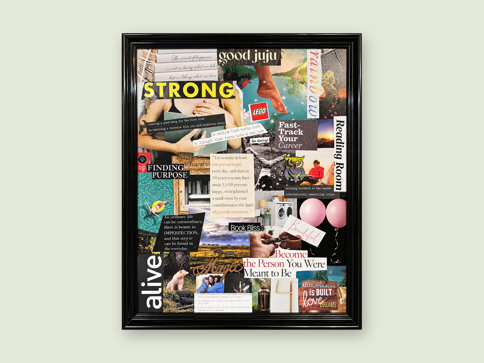 A finished vision board in a black frame